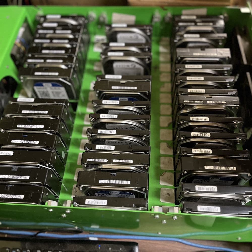 Hard drives seated in a green tray